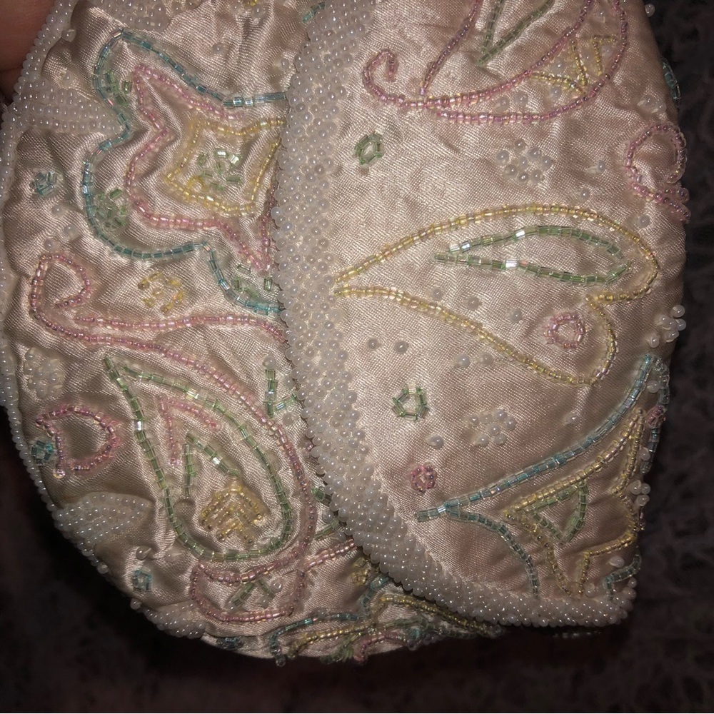 Cream Clutch with Intricate Paisley Pattern and Textured Finish